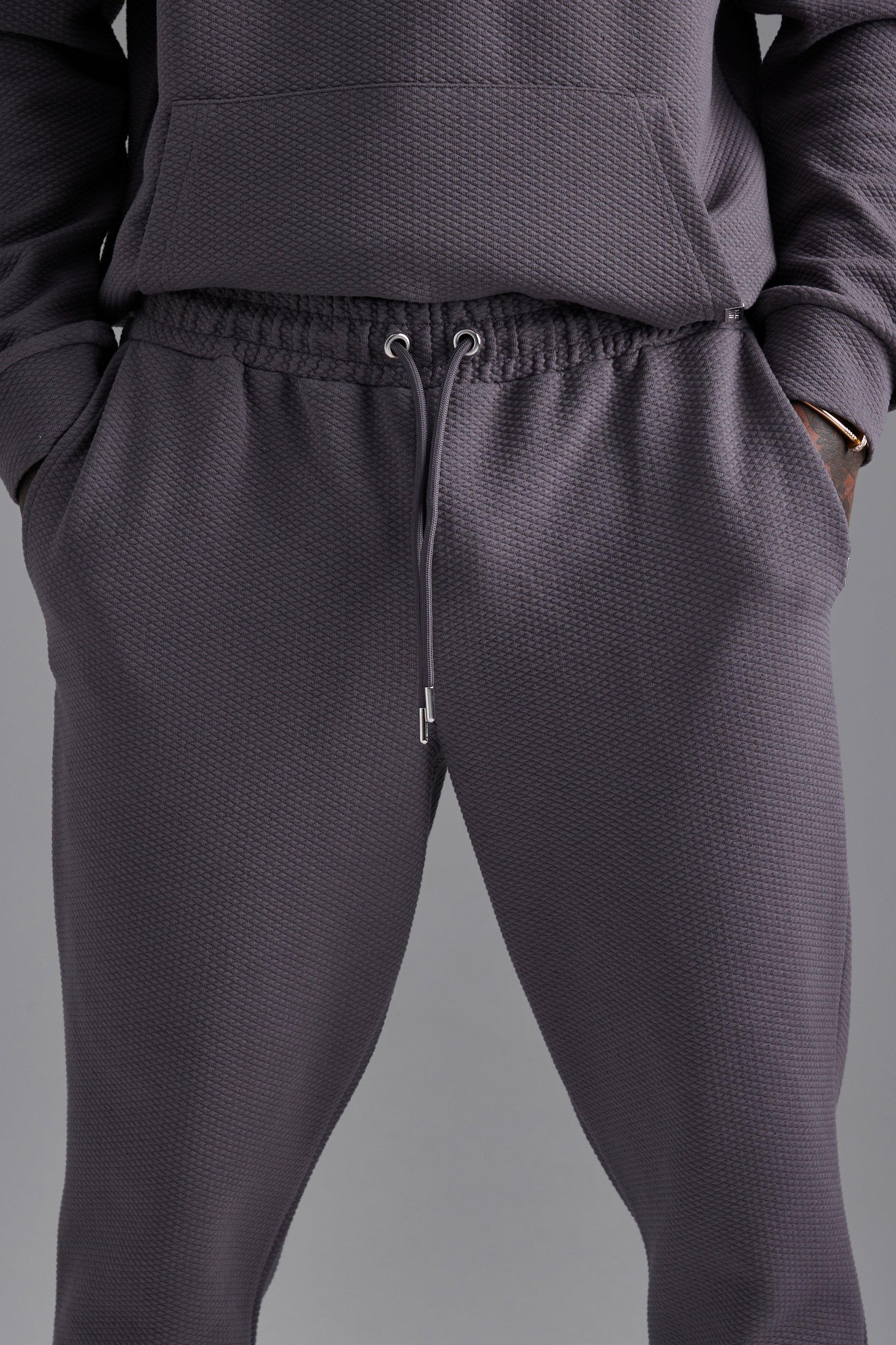 Nette Geruit Gewatteerde Toelopende Joggingbroek Met Stiksels